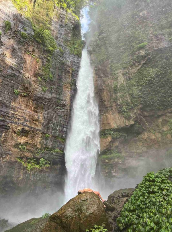 Kapas Biru Waterfall in East Java surrounded by lush green cliffs – hidden gem in Indonesia